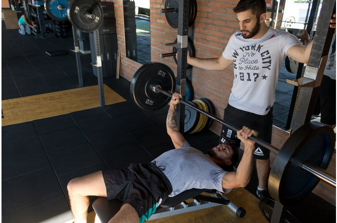 a personal trainer instructing a trainee